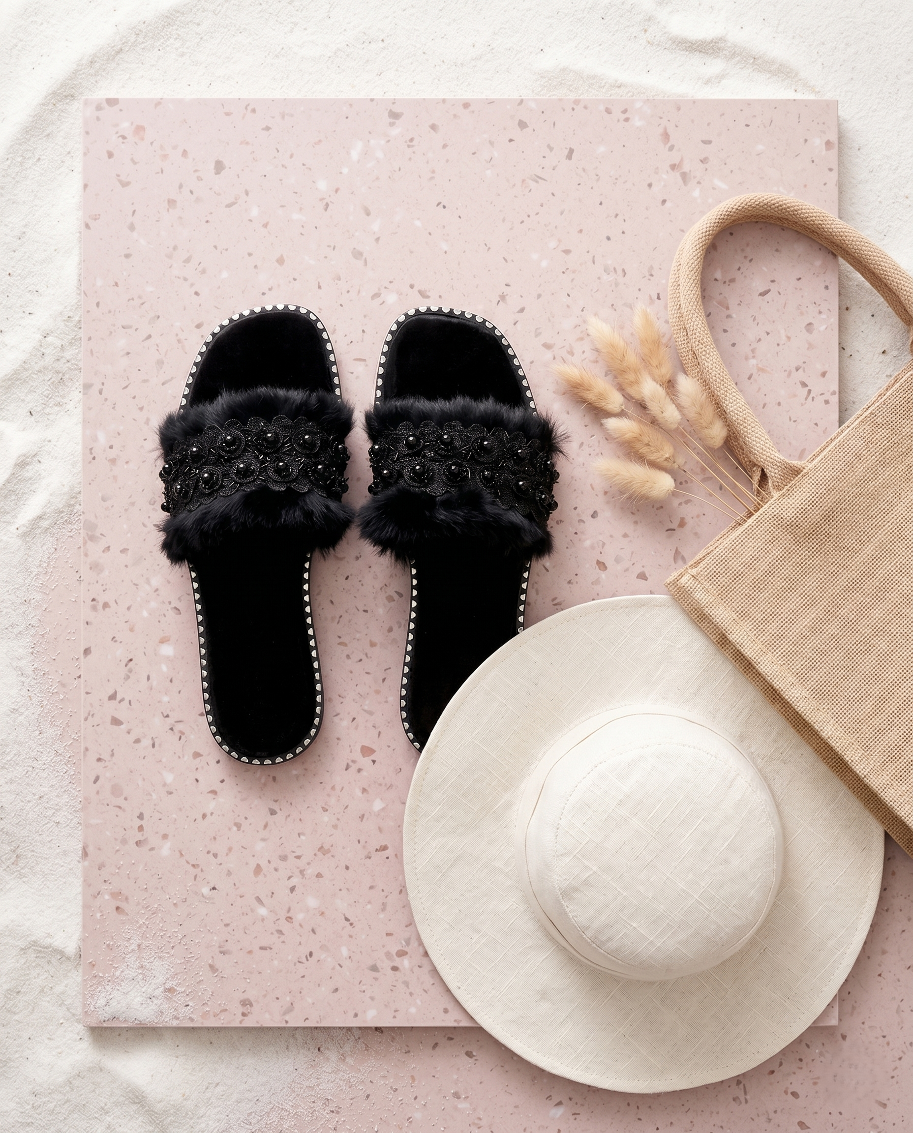 Furry Black slider pair top-down flat lay on pink terrazzo — black fur-textured strap with floral lace and bead embellishment, silver stud sole trim by Solemates by Palak