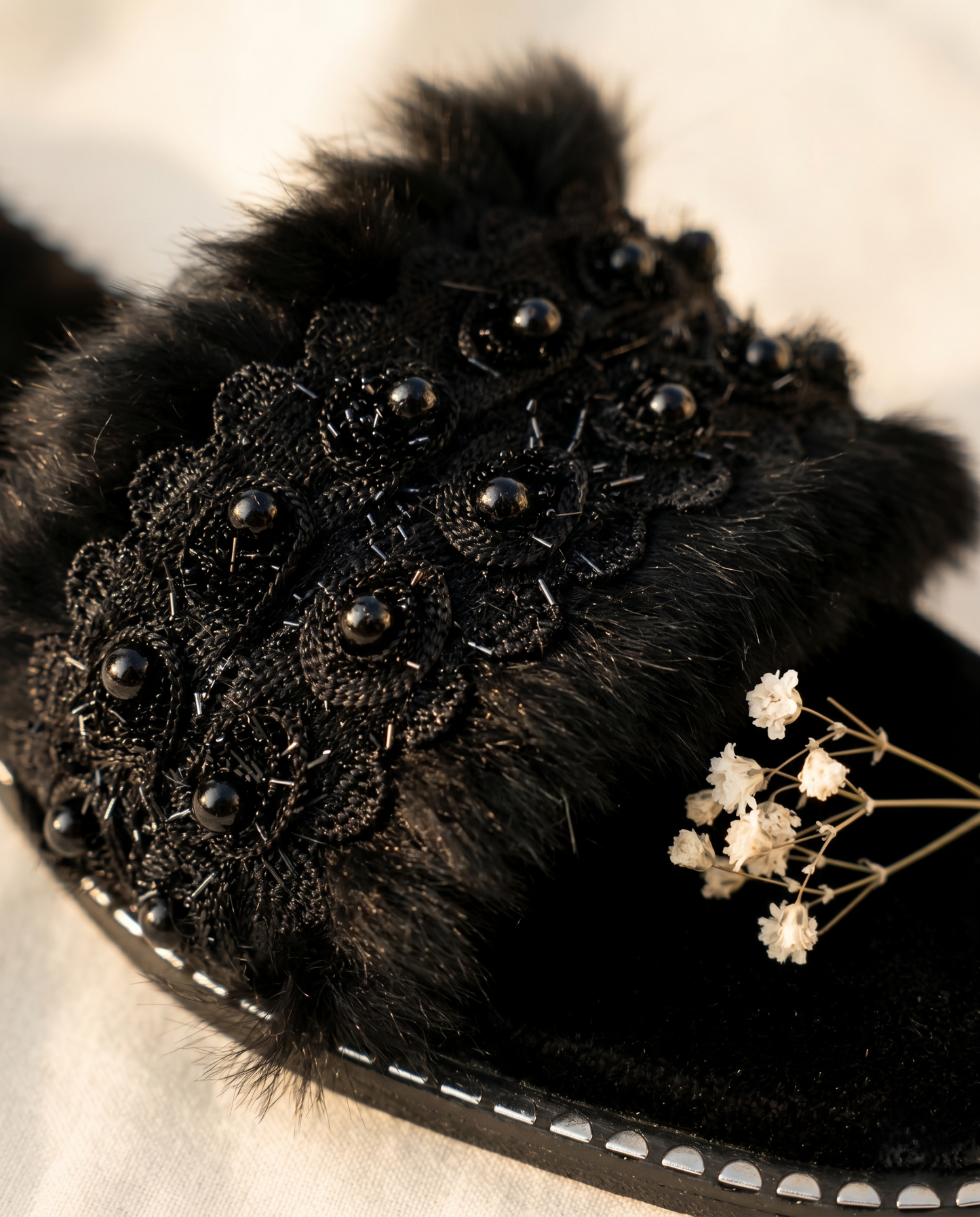 Close-up of Furry Black slider embellishment by Solemates by Palak — black floral lace appliqué with glossy dome beads and bugle bead detailing on black fur-textured strap